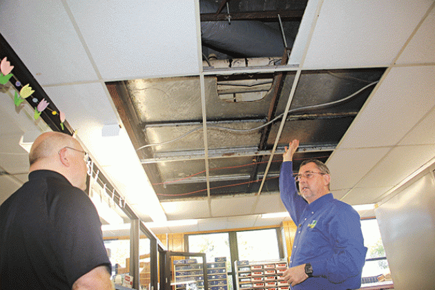 St. Landry Parish President Jessie Bellard, right, shows where smelly water flooded Room 206 in the St. Landry Parish Courthouse on Monday. With Bellard is Van Reed, director of emergency preparedness and a parish administrator.