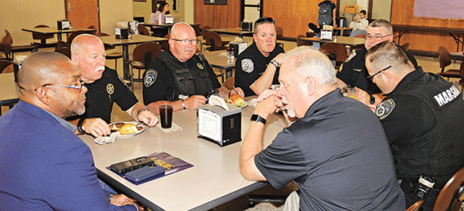 Clockwise from left are J.Tyrone Glover, a field representative for Rep. Clay Higgins; Eunice City Marshal Terry Darbonne; Eunice Deputy Marshal George Cain; LSUE Security Director Cory Lalonde; LSUE Sgt. Andy Gaspard; Eunice Chief Deputy Marshal Joey Peloquin; and Eunice Police Chief Kyle LeBouef. (Photos by Harlan Kirgan)