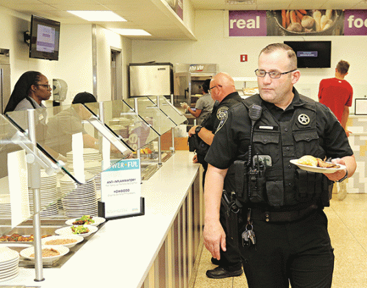 Eunice Deputy Chief Marshal Joey Peloquin goes through the serving line at LSUE as part of a program by LSUE Dining to honor local heroes.