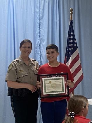 St. Edmund student Rider Ward received the Life Savers award during the DARE graduation from DARE Officer Ashley Boudreaux.