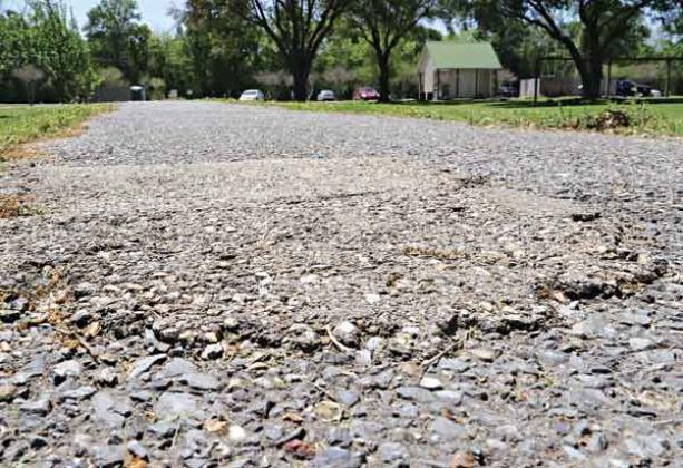 The asphalt track at the walking park is to be widened and repaved with concrete using a $400,000 state grant. (Photo by Harlan Kirgan)