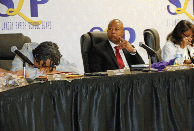 After about two hours in closed session and another hour of meeting left, St. Landry Parish School Board member Hazel Sias briefly put her head down. The Board decided Thursday night to oust Superintendent Patrick Jenkins, center, in a buyout. At right is Board President Joyce Haynes. Jenkins will be paid through June 30 when his contract expires. (Photo by Harlan Kirgan)