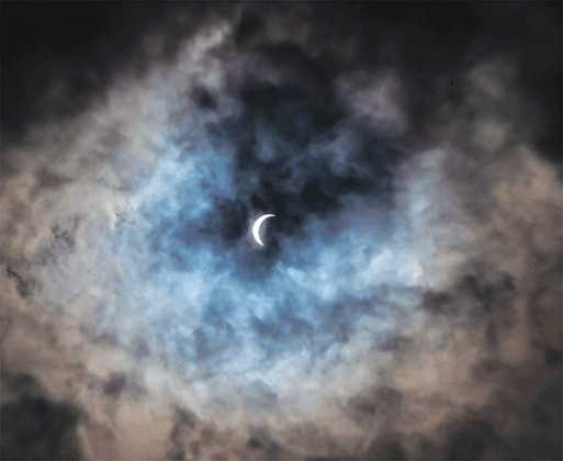Eunice photographer Dwight Jodon captured a photo of the eclipse peaking through the clouds on Monday.