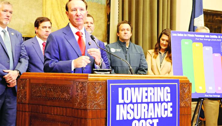 Gov. Jeff Landry speaks to reporters about his legislative agenda to bring down high auto insurance rates on April 9. (Photo by Wes Muller/Louisiana Illuminator)