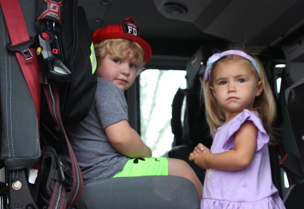 Future firefighters? At left are Beau Trosclair and Amelie Babineaux. They had an opportunity to sit inside a Eunice fire truck during Wednesday’s Story Time held at the Northwest Community Center.