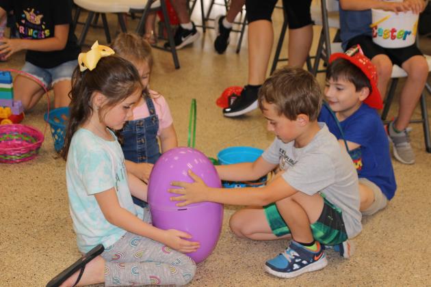 Playing with a large purple plastic Easter egg at Story Time were from left, Tinzley Garris, Leanne Sanders, Trace Sanders and Cooper Richard. (Photos by Myra Miller)