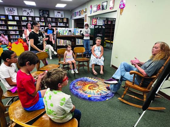 Local scouts with Jena Donaldson during library week.  (Photo by Rebecca Chaisson)