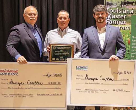 Dwayne Compton, of Jefferson Davis Parish, was named the 2021 Outstanding Master Farmer. He is pictured with Stephen Austin from Louisiana Land Bank and Eric Bergeron with the Gowan Company, who each presented him with a check for $1,000. (Photo by V. Todd Miller/LSU AgCenter)