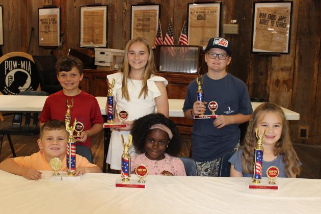 Students who participated and placed in an Americanism essay contest, sponsored by the VFW Post 8971 and Auxiliary were recognized Wednesday evening. Seated, from left, are Brantley Briscoe, Josi Mitchell and Allison Clark. In back, from left, are Jay D. Miller, Ainsley Fruge and Carter Fletcher. Not pictured are Jasper Woolley, Austin Ortego, and Kate LaHaye. (Photos by Myra Miller)