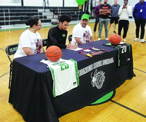 Eunice High senior DeAndre Reed signs on the dotted line to play at Community Christian College in Lafayette on Monday afternoon.