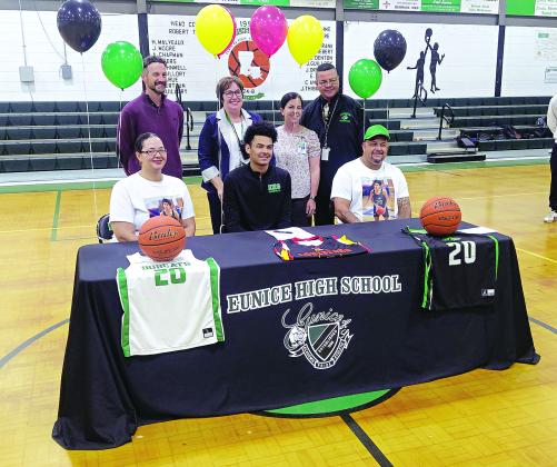 Eunice High senior DeAndre Reed is all smiles after signing a Letter of intent to play at Lafayette’s Community Christian College. He is pictured with his parents and Eunice High administrators Chad Andrepont, Irma Trosclair, Rachel Smith and Dexter Brown. (Photo by Rhett Manuel)