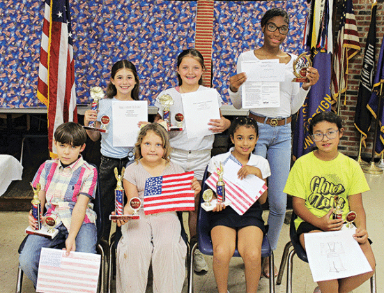 The VFW Post 8971 and Ladies Auxiliary sponsor Americanism essay contests each year. Winners were named. Seated from left are Adam Vidrine, Gracie Soileau, Rynlee Pierre and Emma Carriere. Back from left are Jo Anna Leger, Clara Leger and De’Zira Thomas. (Photo by Myra Miller)