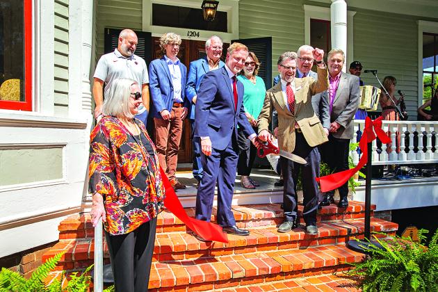 Representatives of UL Lafayette, its Center for Louisiana Studies and contributors to the recent renovation of the Roy House attended a Thursday ribbon-cutting ceremony. Shown, from left, are: Dr. Vaughan Baker, former department head; Scott Hebert, director of Facility Management; Scott Chappuis, Architects Beazley Moliere; Robert “Popie” Billeaud, J.B. Mouton Builders; Dr. Joshua Caffery, center director; Rita Durio, Rita Durio and Associates; Dr. Jordan Kellman, College of Liberal Arts dean; Dr. Joseph S