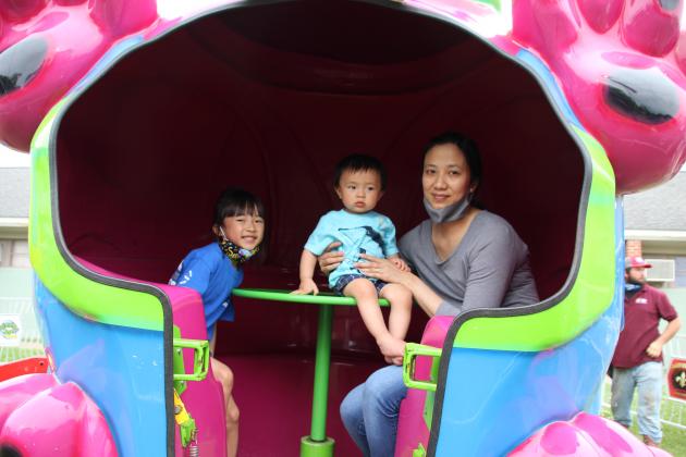 A family on the Puppy Roll fair ride at St. Edmund.