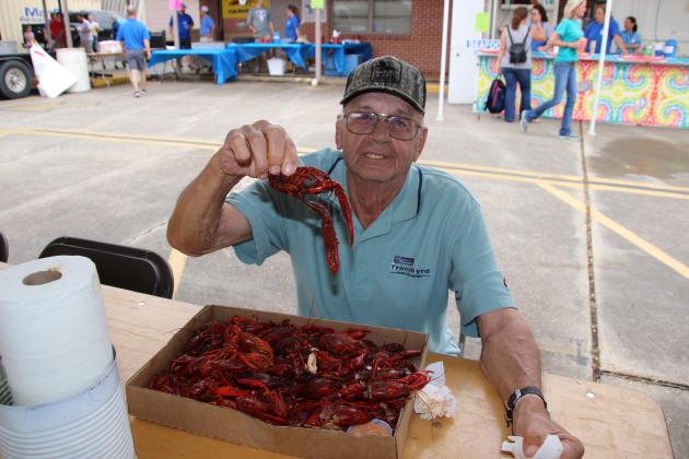 Bobby Brown of Eunice eats boiled crawfish at St. Ed Fair.