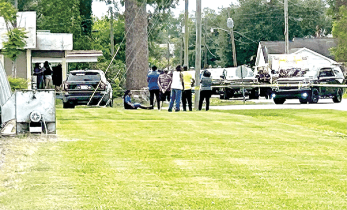 Neighbors surround police tape Monday afternoon at a home located at the corner of East Harrop and North Chevis in Rayne, while the Louisiana State Police Bureau of Investigations began their investigation of an officer-involved shooting resulting in the death of a Rayne Police officer, 47-year-old Lt. Allen “Noochie” Credeur Jr., a 22-year veteran of the Rayne Police Department who was also a long-time member of the Rayne Volunteer Fire Department serving as captain for many years. Police were called to th