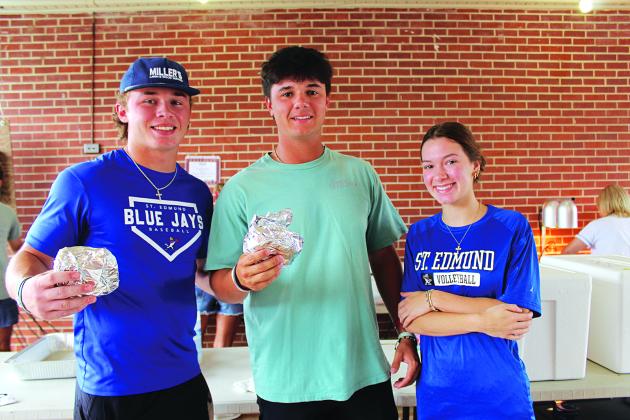 St. Edmund students work the hamburgers booth. From left are Blake Moran, Michael Brown and Emma Clause.