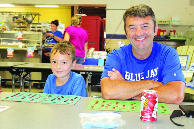It’s Bingo time at the St. Edmund Spring Fair. From left are Levi LeBleu, 6, and his father Shane LeBleu.