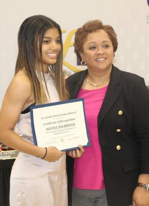 Destiny Malbrough, of Eunice High School, is one of 15 St. Landry Parish students who are scheduled to received associate degrees from LSU Eunice on May 19, which is the same day she graduates for high school. With Malbrough is interim St. Landry Parish Superintendent Dwanetta Scott at the May 4 School Board meeting. The 15 St. Landry Parish public school students receiving associate degrees at LSUE is a record for the parish. (Photo by Harlan Kirgan)
