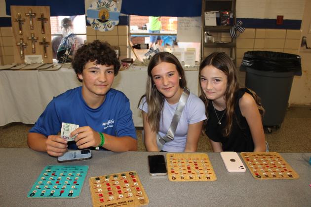 Playing Bingo Saturday at the St. Edmund Spring Fair were Carson Simon, left, Leah Scheufens and Arabella Mouton.