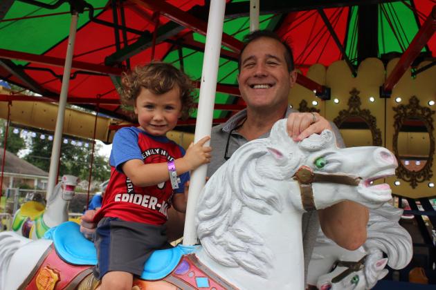 Kids and adults alike enjoyed the carnival rides at the St. Edmund Spring Fair Saturday. Thomas Person, 2-1/2-year-old grandson of Dr. Monty Heinen enjoyed his ride on a horse.