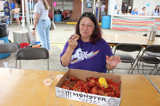 Wendy Arnaud of Eunice enjoys 3 pounds of boiled crawfish at St. Edmund Spring Fair Saturday.