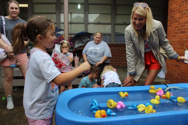 Riley Garcille at duck pond at St. Ed Spring Fair