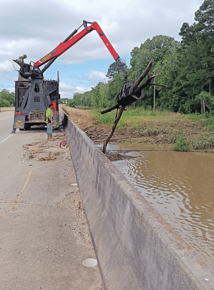 Debris was removed from Bayou Des Cannes on Monday and Tuesday by St. Landry Parish Government crews. Parish Council member Ernest Blanchard said three truck loads of debris were removed and the job is not done. The photo was taken on U.S. 190 west of Eunice. (Submitted photo)