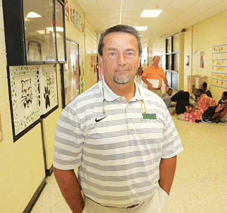 Eunice High School Principal Mitch Fontenot is in the front hall of the school in this photo from 2018. Fontenot plans to retire from Eunice High in June. He said he will continue his career as principal at St. Edmund High School. (Photo by Harlan Kirgan)