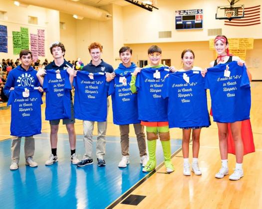 Coach Clay Harper recognized students earning all A’s at St. Edmund’s Academic Pep Rally. From left, are John Logan Floyd, Alexander Ortego, Henry Summerlin, Hayden Bertrand, Ross Bertrand, Lauren McGee and Madison Comeau.