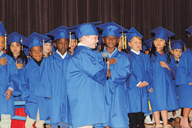 Leading the Pledge of Allegiance during the morning ceremony are Brenton Andrepont and Daviyanna Darby.