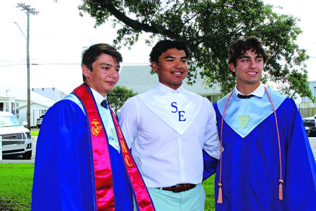 St. Edmund High seniors David Evans, left, Marcus Gradney Jr. and Ian Rider are seen outside after St. Edmund’s graduation ceremony.