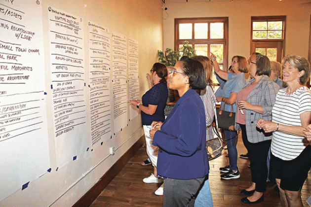 Eunice Alderwoman Germaine Simpson, center, decides where to place a marker on ideas for downtown Eunice at a meeting Tuesday at Gabrielle’s to develop a roadmap plan to be presented at 5:30 p.m. today,also at Gabrielle’s. The plan will also be presented on youtube.com. (Photos by Harlan Kirgan)