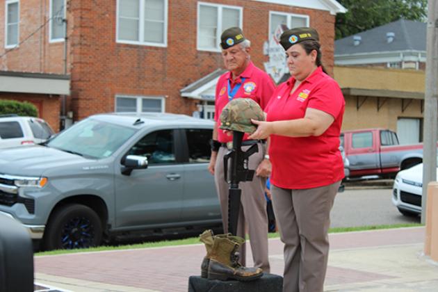Pepper Manuel with VVA Chapter 215 places a soldier’s helmet.