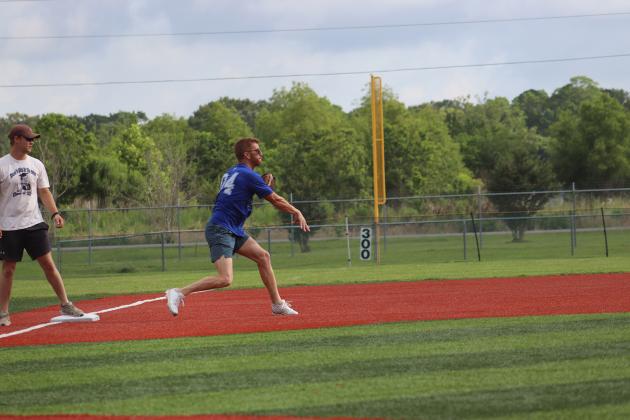 Joseph Bischoff, class of 2004, makes a play from 3rd base as Wesley Lafleur, class of 2023, 3rd base coach, looks on.