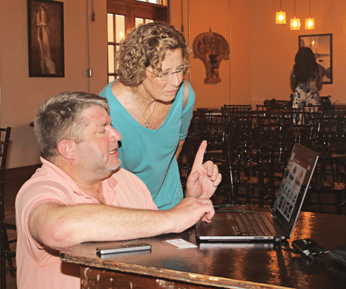 Celeste Gomez looks over a plan for downtown Eunice with presenter Tripp Muldrow at a meeting Thursday at Gabrielle’s. (Photo by Harlan Kirgan)