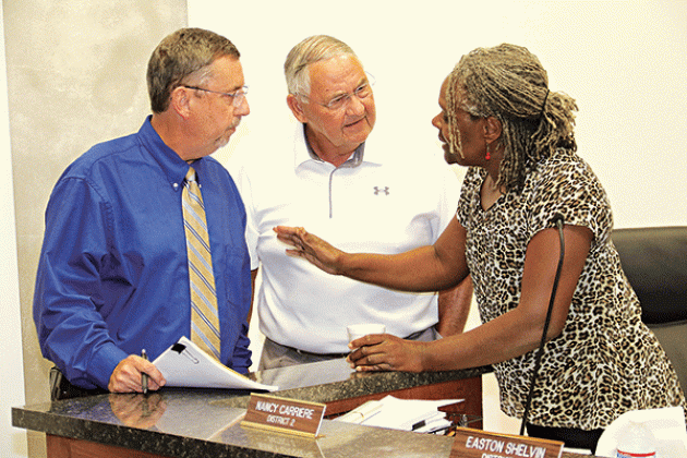 St. Landry Parish Council member Nancy Carriere, right, became a peacemaker after a heated exchange between Parish President Jessie Bellard and Council member Harold Taylor at Wednesday’s meeting in Opelousas. (Photo by Harlan Kirgan)