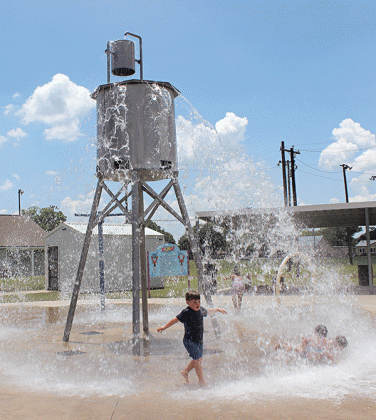 Wyatt Fink, 5, cools off at the Splash Pad at the Fairgrounds on Thursday afternoon. Children are nowing enjoying their summer by cooling off at the splash pad. The splash pad is opened every day from 10 a.m. to 6 p.m. Another splash pad is located directly behind Central Middle School. (Photo by Myra Miller)