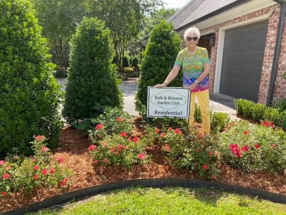 The home of Jeremy James and Hoby Givens at 137 Dan Drive were the recipient of Residential Garden of the Month presented by the Eunice Bulb &amp; Blossom Garden Club. The home features flowering beds of roses, hydrangea, Bottle bush, miniature boxwood, and gardenia. Volunteer member pictured is Lana Henderson.