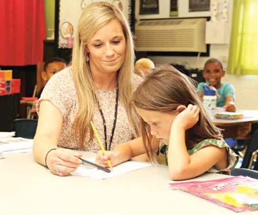 Glendale Elementary teacher Keesha Huval assists Zailynne Taylor during a Camp Accelerate class on Tuesday. (Photos by Harlan Kirgan)