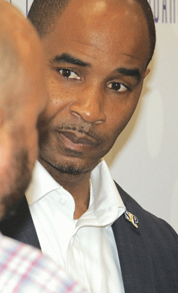 Milton Batiste, St. Landry Parish school superintendent, speaks with a School Board member on Thursday. (Photo by Harlan Kirgan)