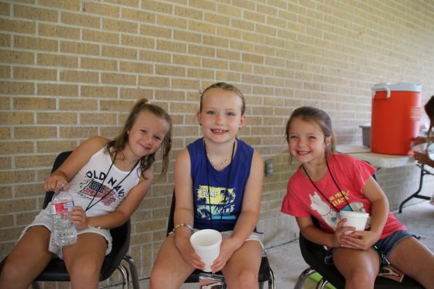 A water break is a good thing when children are outdoors enjoying a game of ball with adult leaders at Vacation Bible School held at St. Thomas More Church. From left, are Ella Mire, Ellie Feucht and Clara Leger, all second graders.