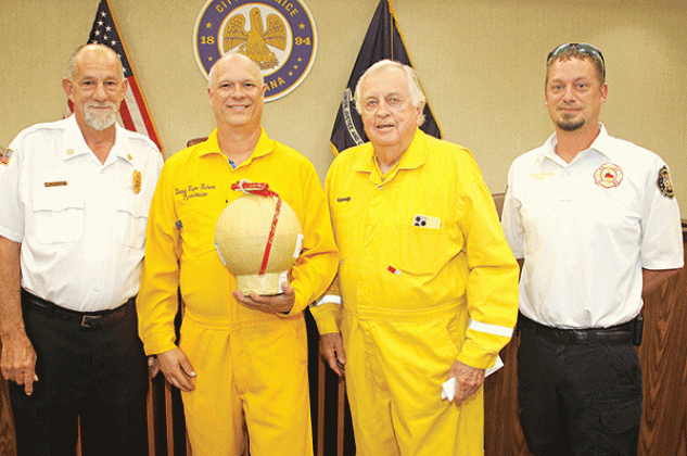 Fireworks were discussed at Tuesday’s Eunice Board of Aldermen’s meeting. Former Mayor Kenneth Peart, third from left, said he is stepping back from his role as the lead in staging the Fourth of July show at the Recreation Complex. From left, are Acadia Parish Fire District 4 Chief Harral “New York” Johnson; Donald Richard, who is taking the lead for the fireworks show and holding an aerial shell; Peart; and Eunice Fire Chief Chaise Brown. (Photo by Harlan Kirgan)