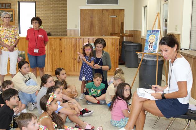 Chasity Fontenot reads to kindergarteners and first graders at VBS at St. Thomas More Church