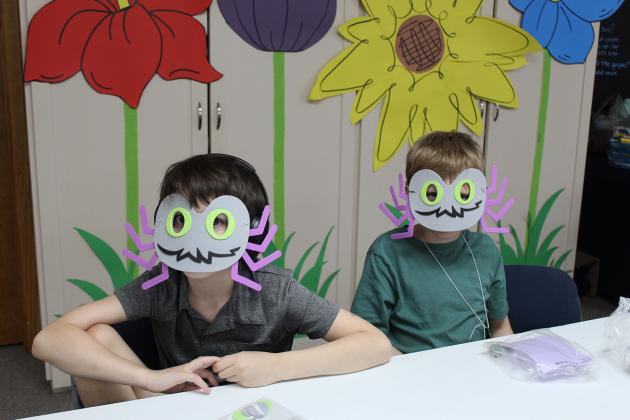 Showing off their finished craft projects, a foam spider mask, are Connor Gallet, left, and Liam Blanchard.