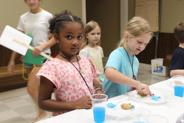 Having and making a special snack into a fish at Happy Days are Amiyah Anderson, 6, and Gemma Marcantel, 6.