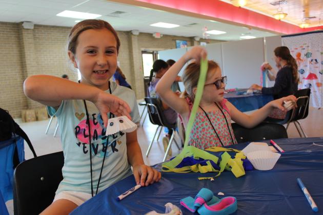 St. Thomas More Catholic Church is holding its Vacation Bible School this week with plenty of arts and crafts for children. From left making a jellyfish are Cassie Ward and Emma Yaun. The theme of the VBS is “Scuba Diving into Friendship with God.”