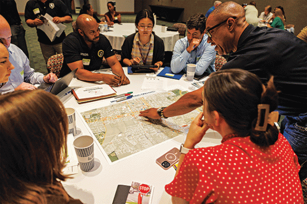 Community leaders from Opelousas mark key locations of the city on a map to assess where sidewalks, crosswalks and bike paths are most needed at the 2024 Louisiana Rural Complete Streets Summit. (Photo by V. Todd Miller/LSU AgCenter)