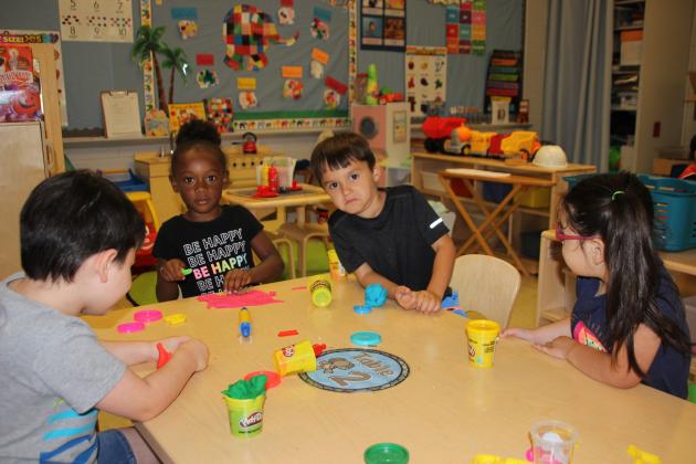 Pizza for lunch is always good on a beach as these pre-k children learned at a Play Dough center to create a pizza. From left, are Aiden LaFleur, Addison Dequir, Ethan Giudry, and Noralyn Bordelon.