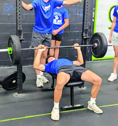 Football player Michael Perron bench presses as part of the St. Ed’s football off-season training program. The program combines elements of weight lifting, CrossFit and practical football practice to give the Blue Jays an advantage they hope pays off in the 2025 season. (Photo by Rhett Manuel)